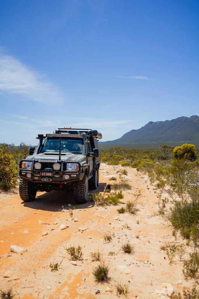Boss-built 6x6 Land Cruiser fitted with a Starlink Mini mount, on a remote outback track