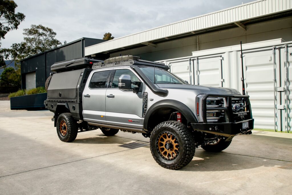 Boss cab rack fitted to a silver Ford F-250/F-350 Super Duty with canopy, front three-quarter view