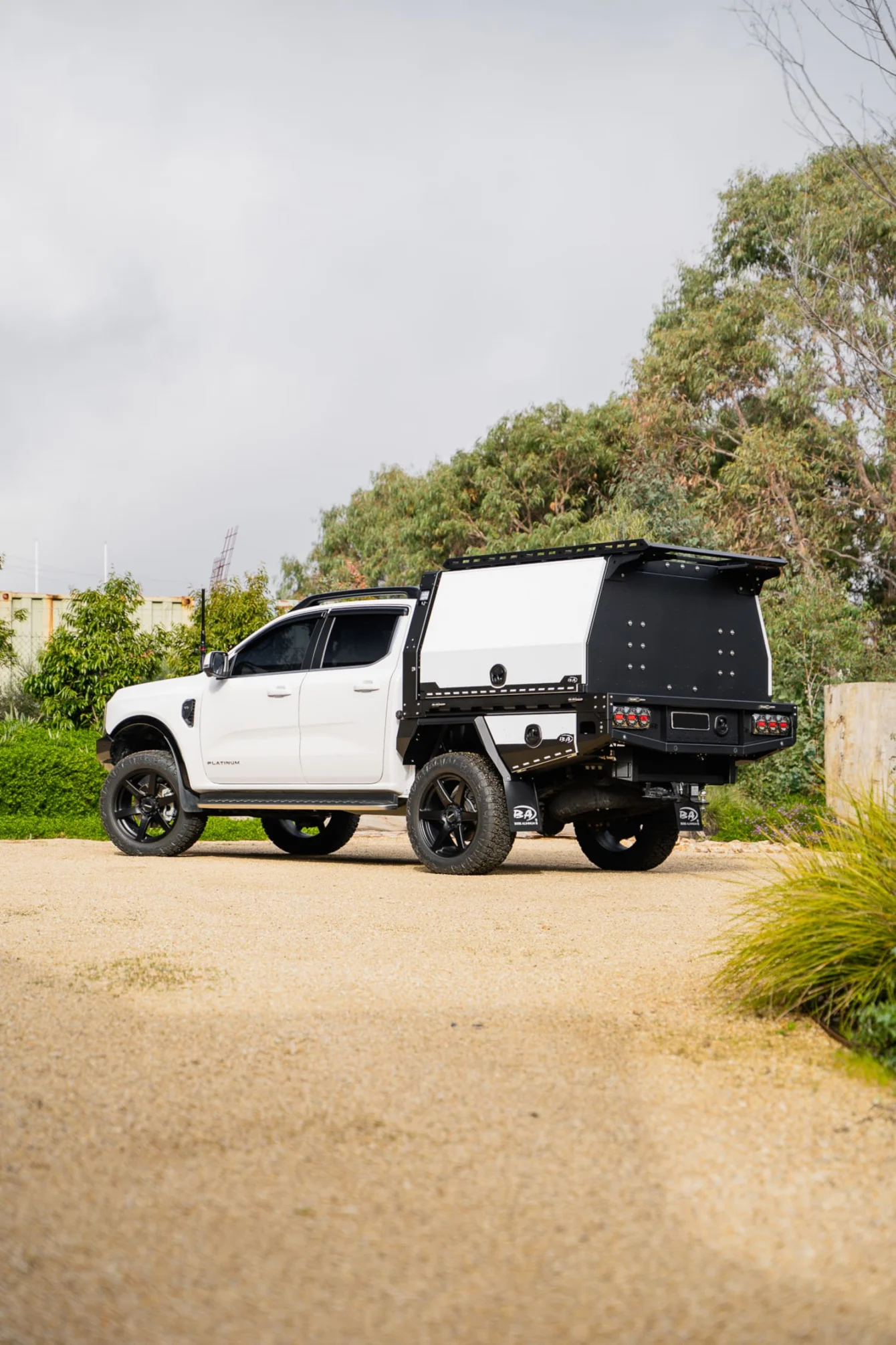 White Ford Ranger dual cab with a Boss tray and canopy
