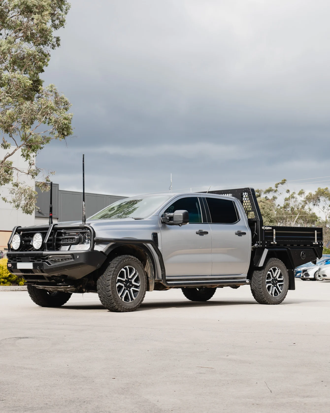 Grey Ford Ranger dual cab with a Boss tray and headboard