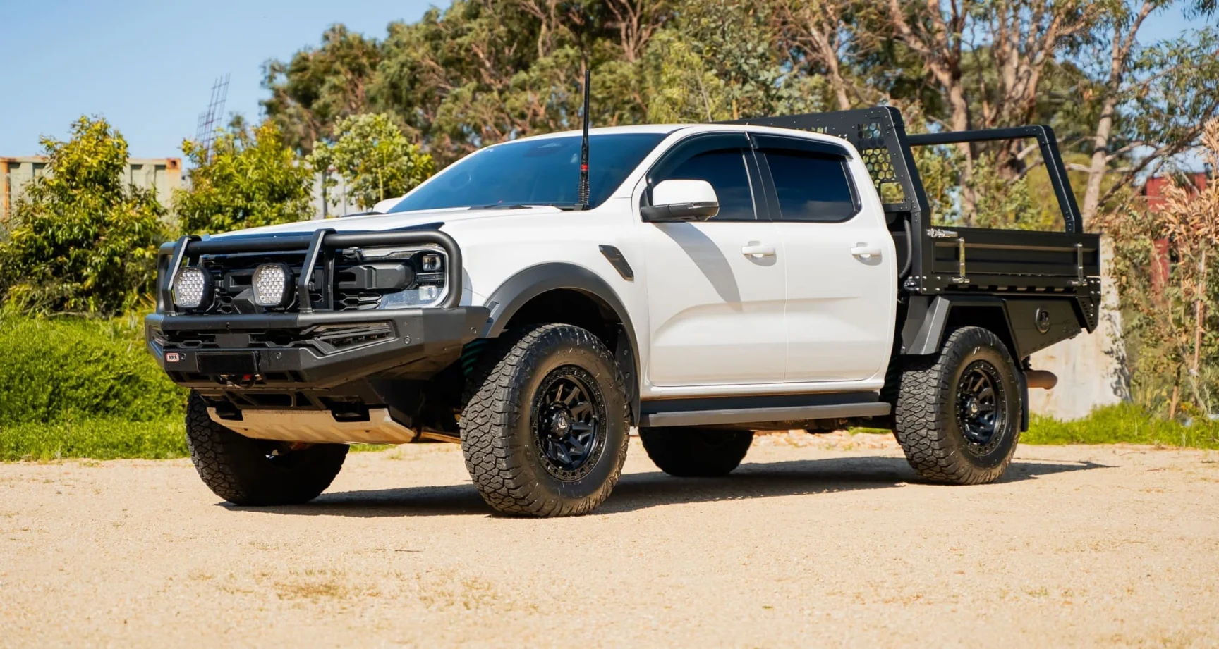 White Ford Ranger Raptor dual cab with a Boss M4 tray